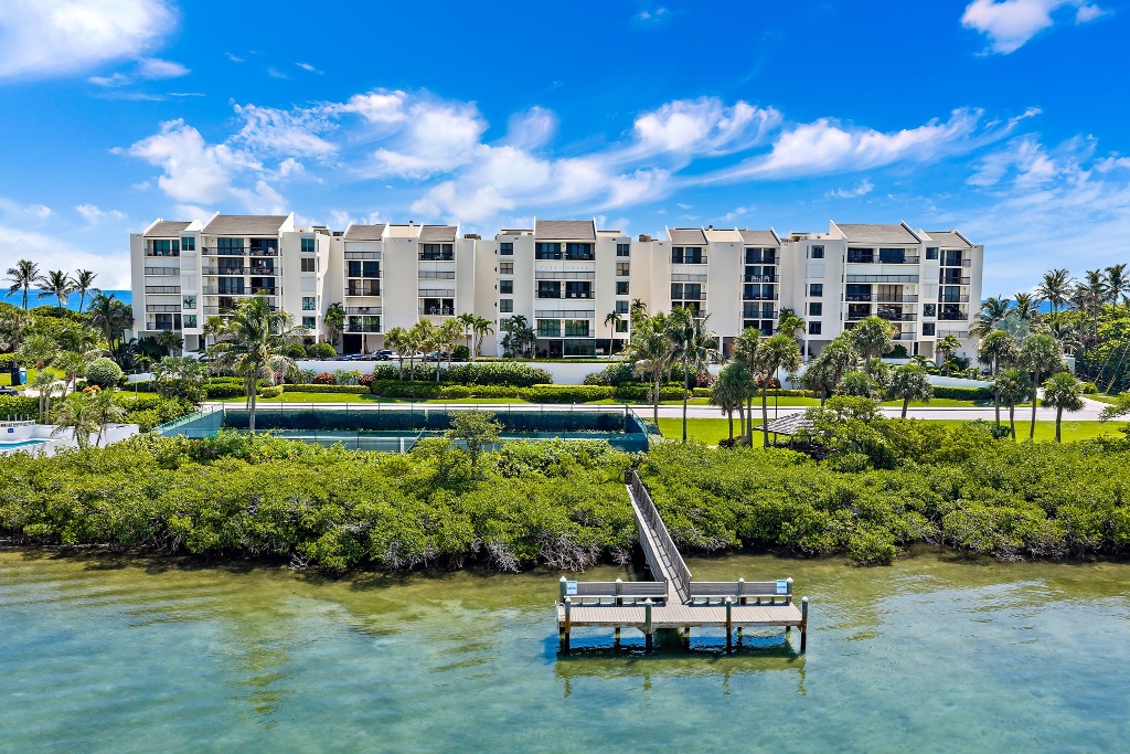 Seawatch at Jupiter Island viewed from the Intracoastal — community day dock and tennis court foreground