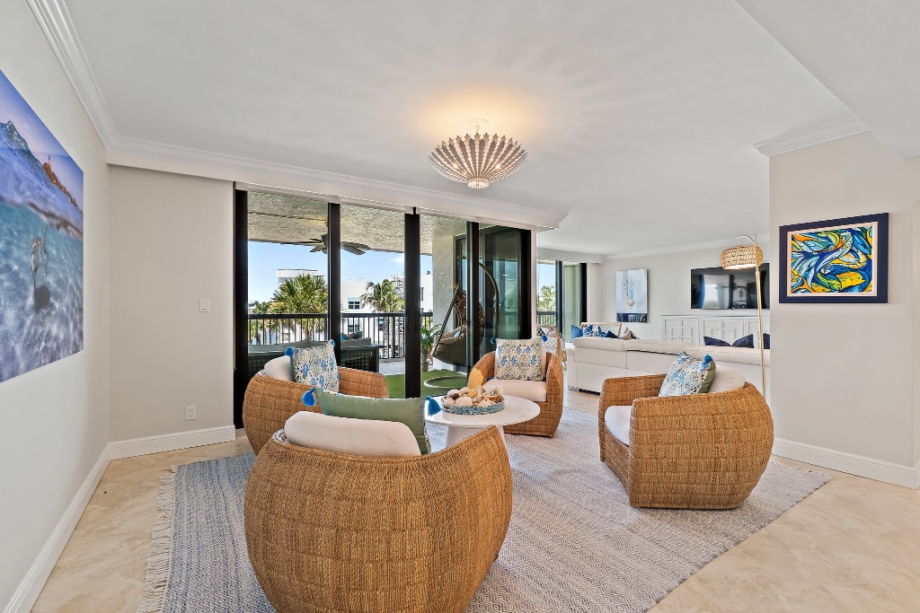 Living and den wide angle — wicker chairs, fish art, Intracoastal views