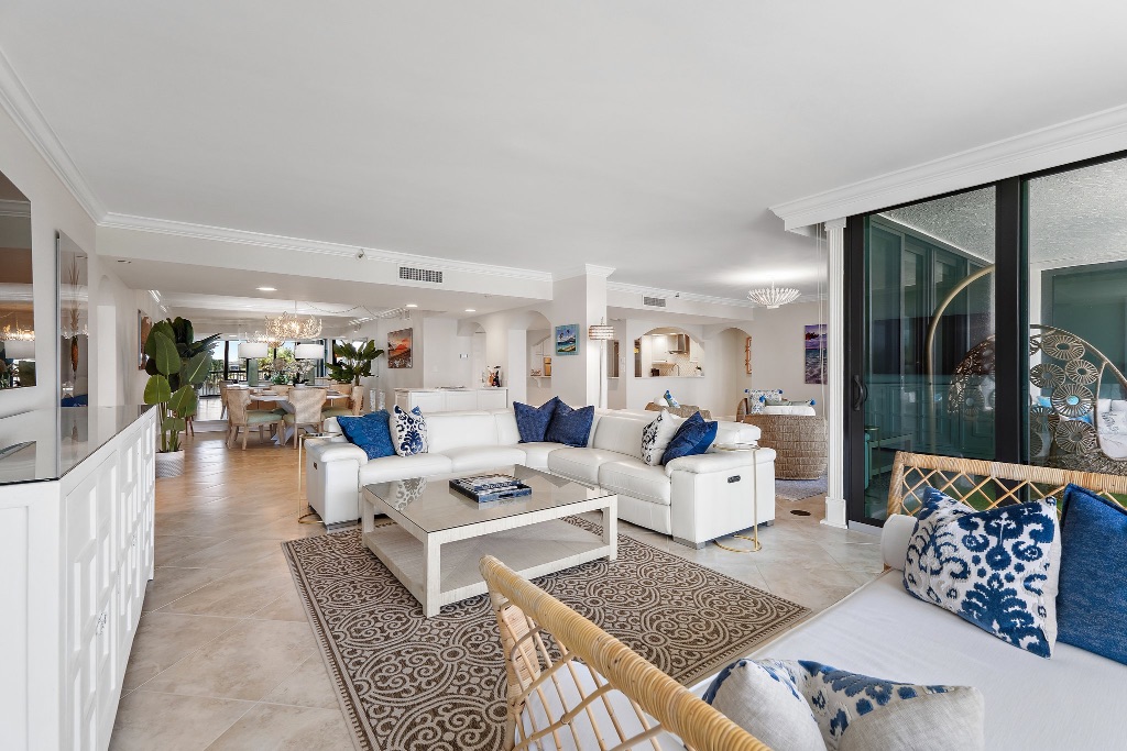 Living room wide view with dining area through arches and kitchen pass-through