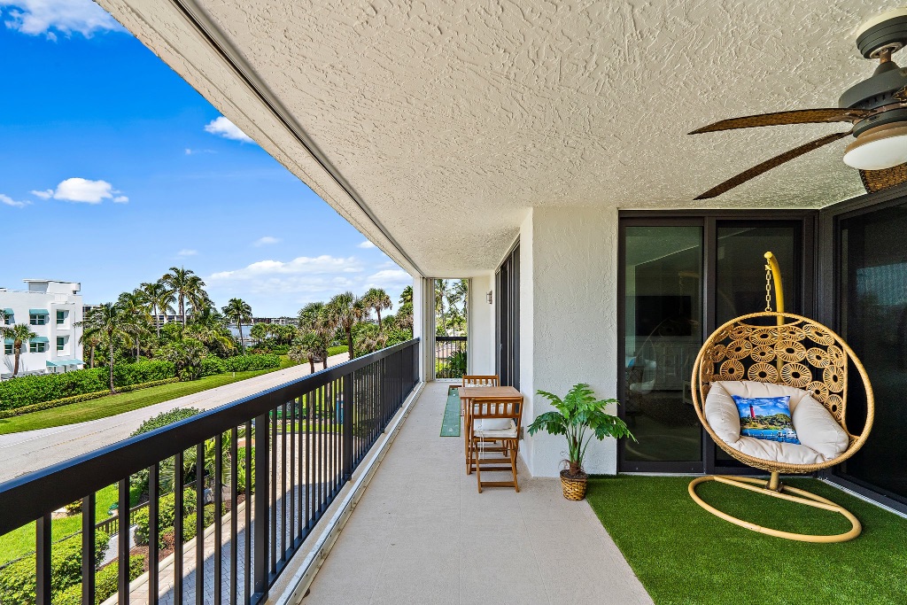 Long wraparound balcony with egg chair and Intracoastal and grounds views