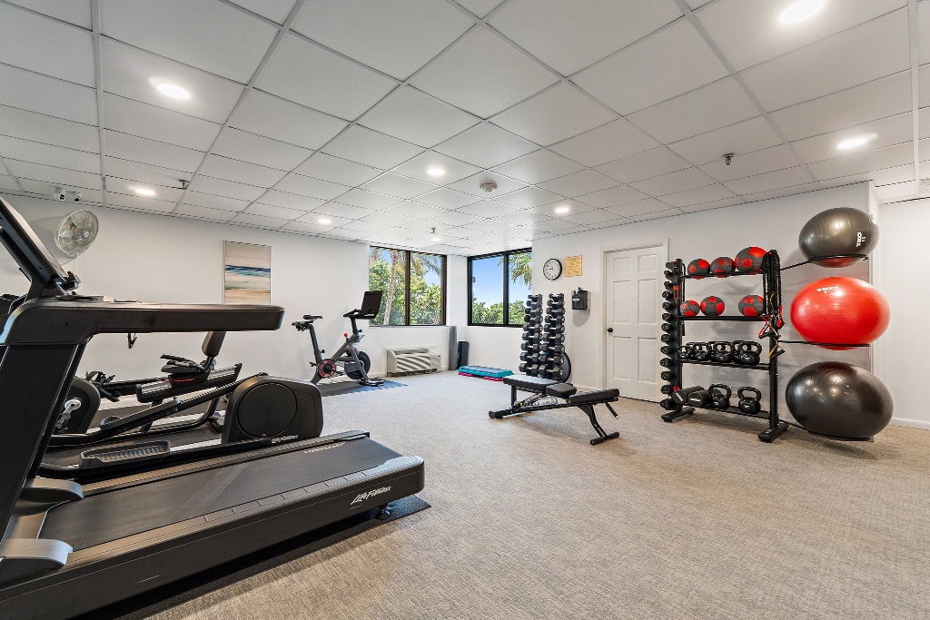 Community fitness center with treadmill, spin bike and weight rack