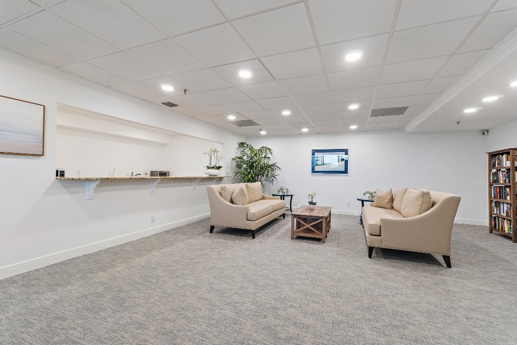 Community club room with sofas, art and bookshelves