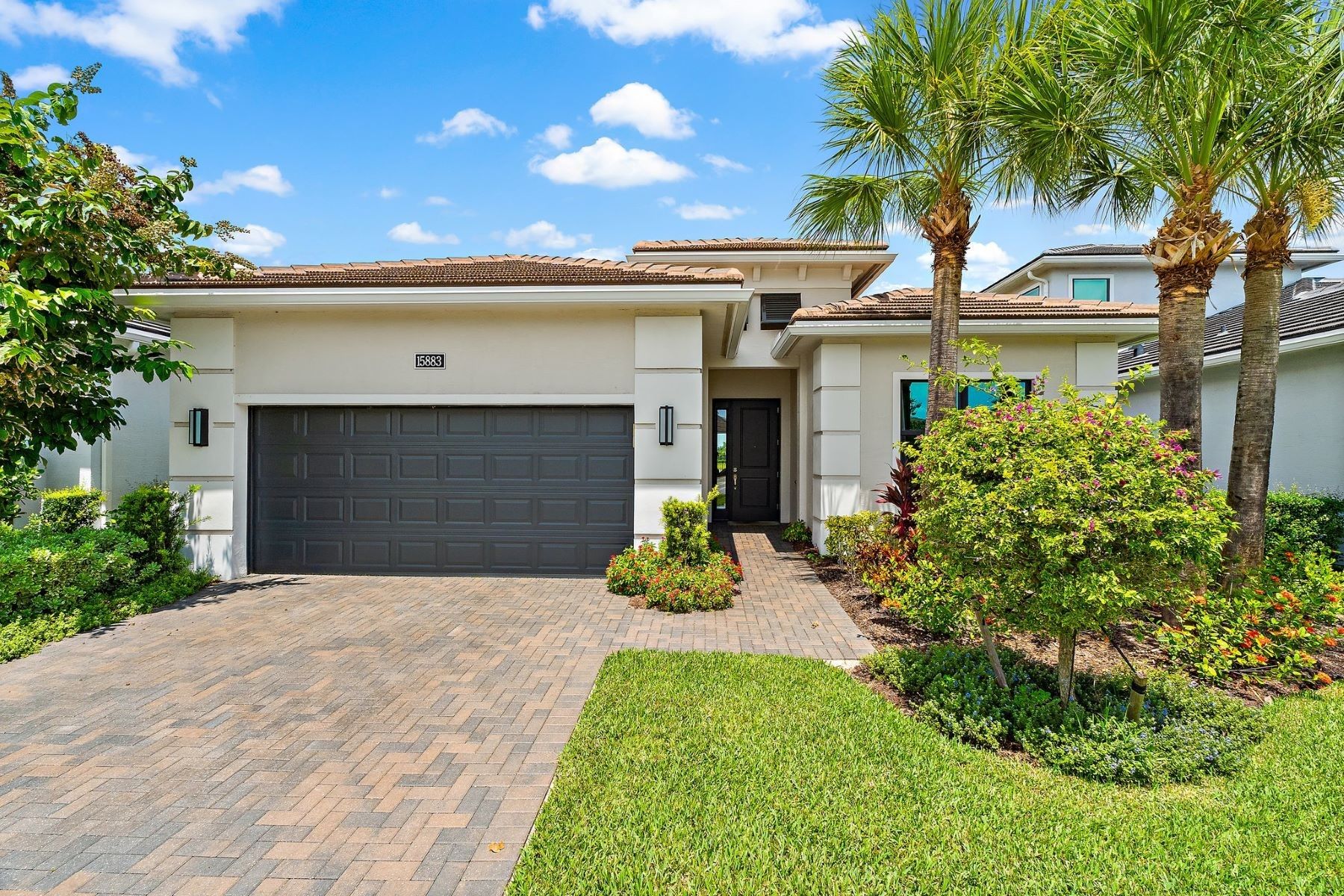 15883 Key Biscayne Lane Westlake FL — front exterior, single-story lakefront home