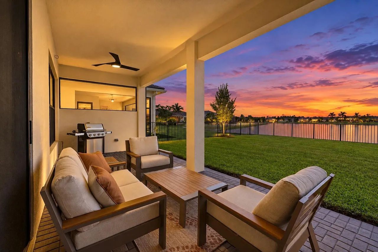 15883 Key Biscayne Lane Westlake FL — covered lanai with outdoor living and lake view