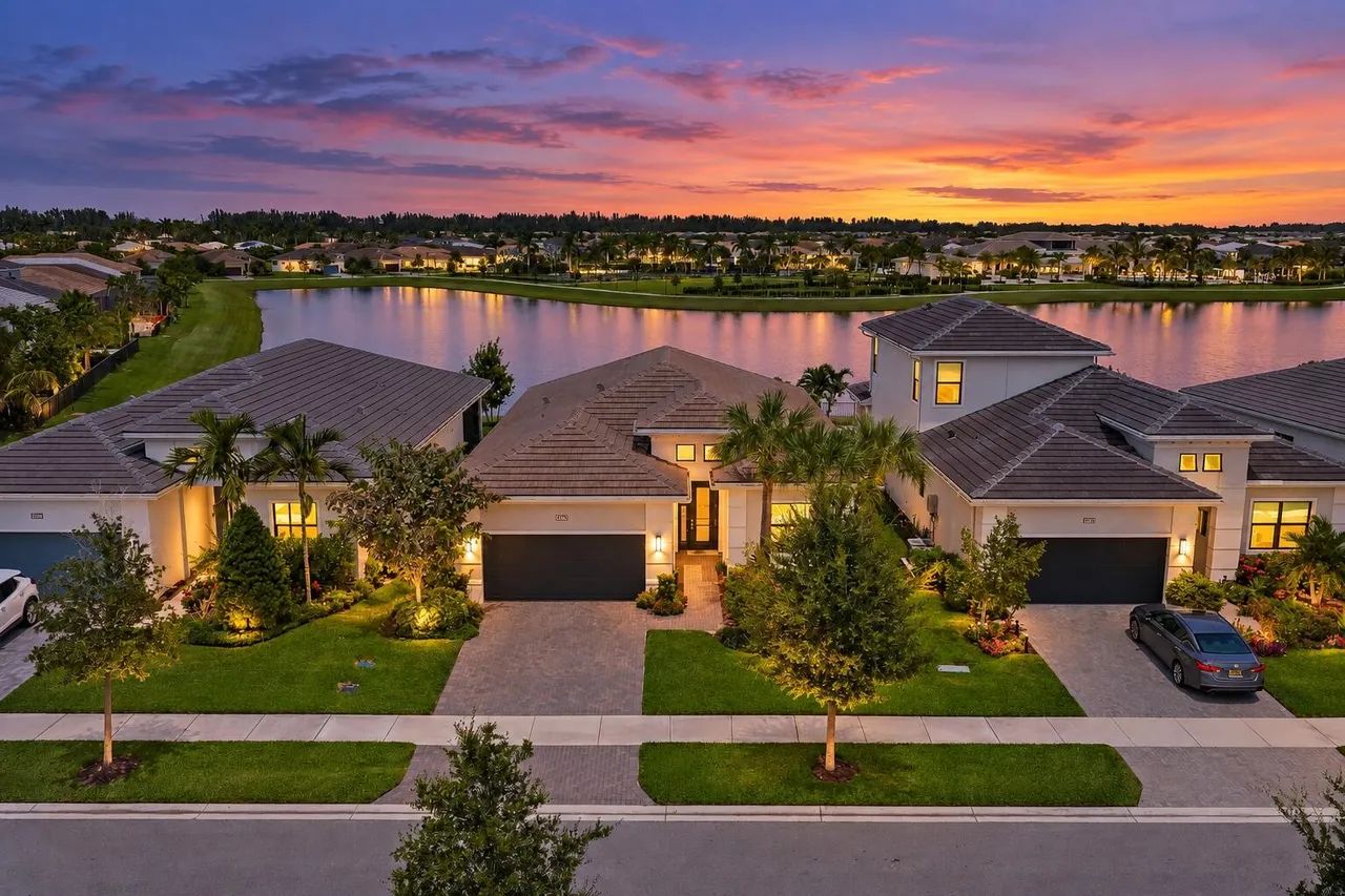 15883 Key Biscayne Lane Westlake FL — twilight aerial showing lakefront setting