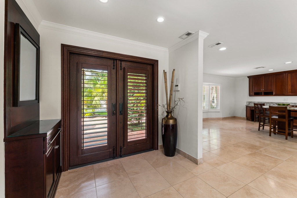 Grand foyer — custom mahogany double doors, travertine floors, 18150 Perigon Way