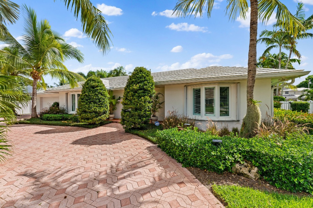 Curving paver driveway flanked by tall palm trees, 18150 Perigon Way