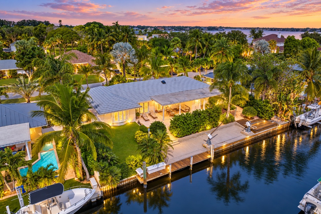 18150 Perigon Way — twilight aerial, private dock and 95-ft canal frontage