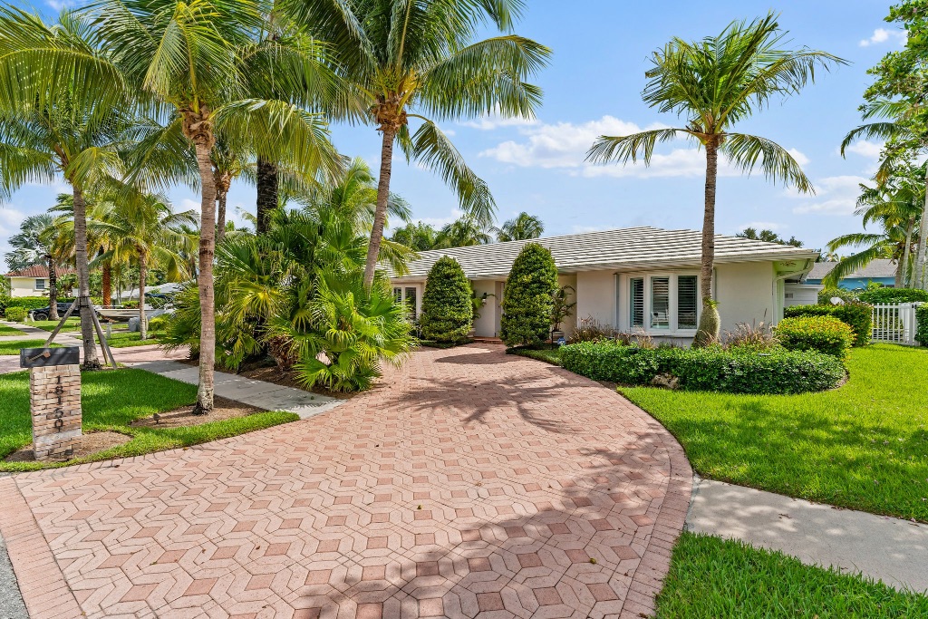 Front exterior — address marker 18150 with mature royal palms