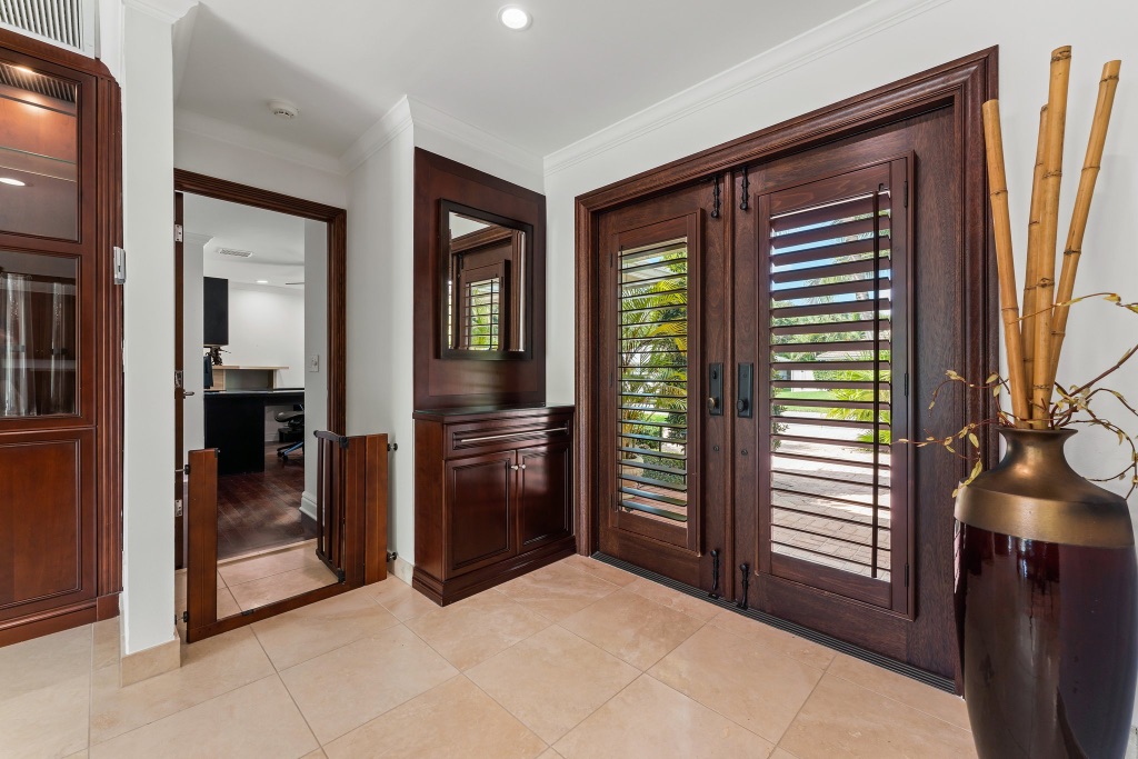 Foyer entry detail — custom mahogany cabinetry and decorative mirror