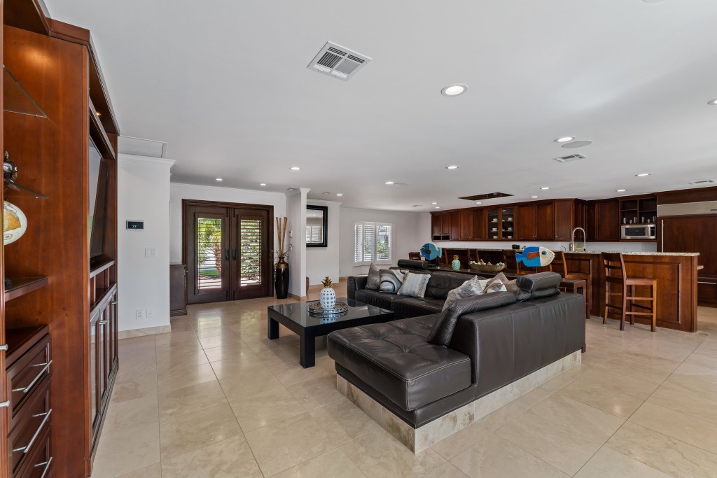 Open-plan great room — living, kitchen and lanai access, 18150 Perigon Way
