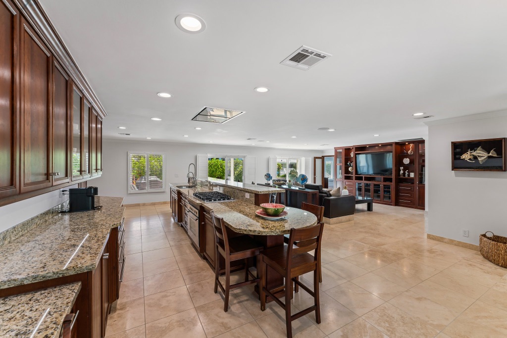 Kitchen — oversized island with seating, lanai views through sliding doors