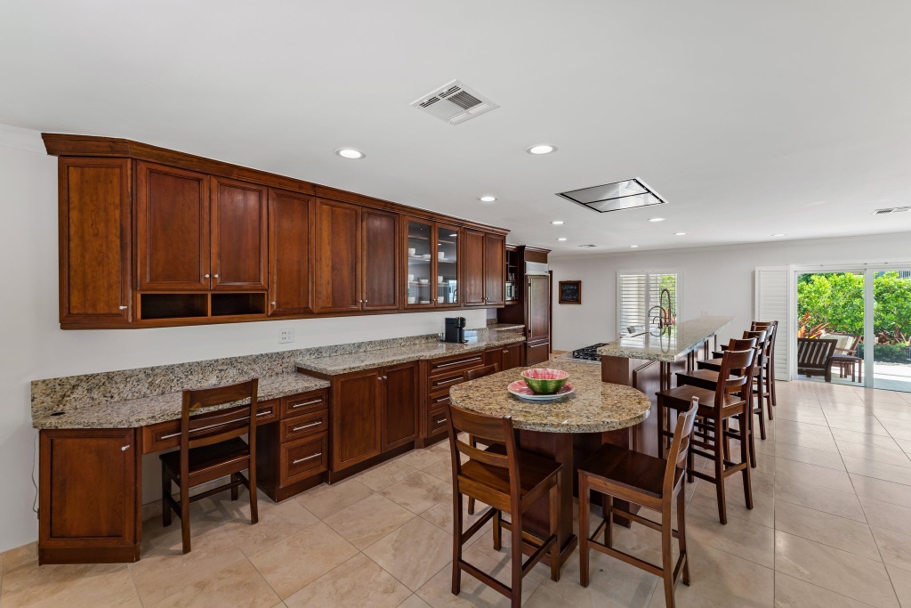 Kitchen — custom mahogany cabinetry, prep bar with seating