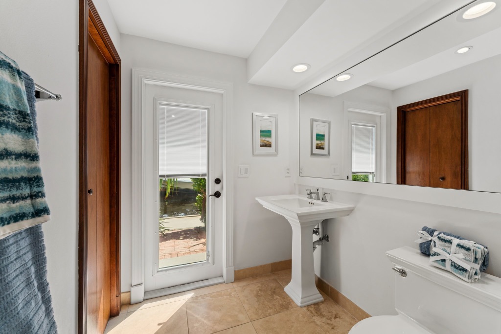 Pool bath — pedestal sink with direct pool and outdoor access