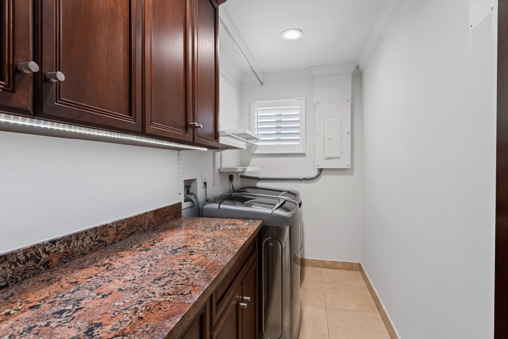 Laundry room — custom cabinetry with granite folding counter