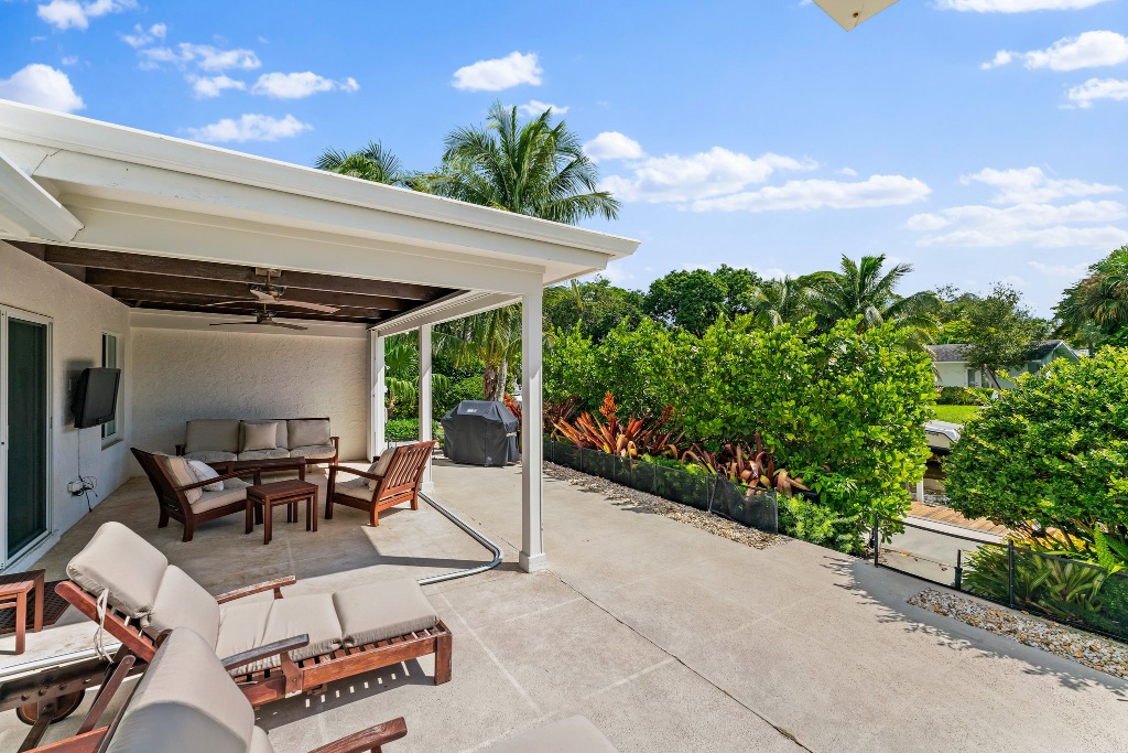 Open lanai — lounge seating with tropical garden views