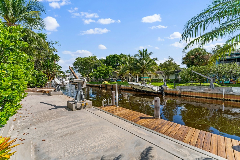 Private dock with boat, davit cranes and Jupiter canal waterways