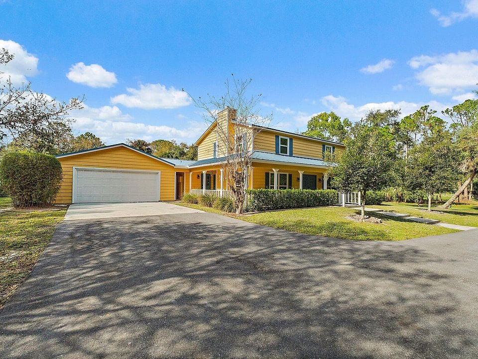 17375 Thunder Road — front facade with porch, two-car garage and landscaping