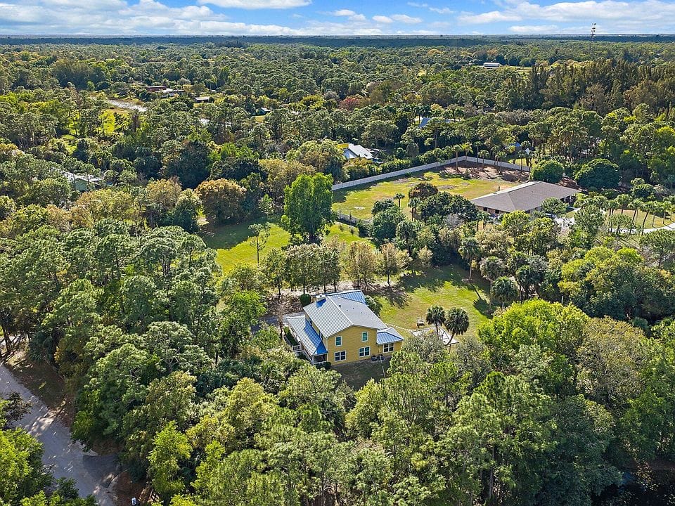 17375 Thunder Road — aerial view showing lush private tree canopy and 2.5 acres