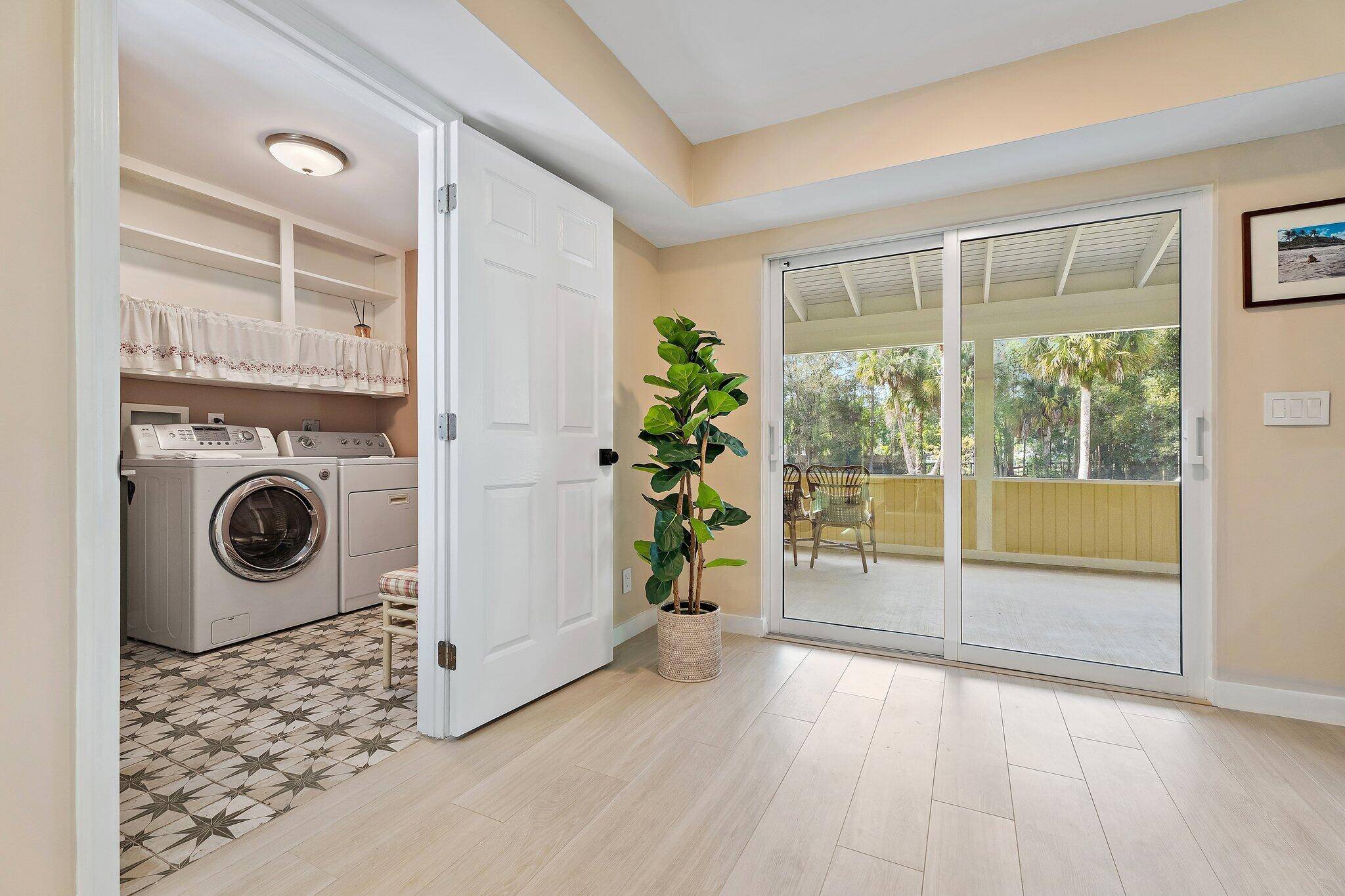 17375 Thunder Road — laundry room with patterned tile and sliding door to covered back porch