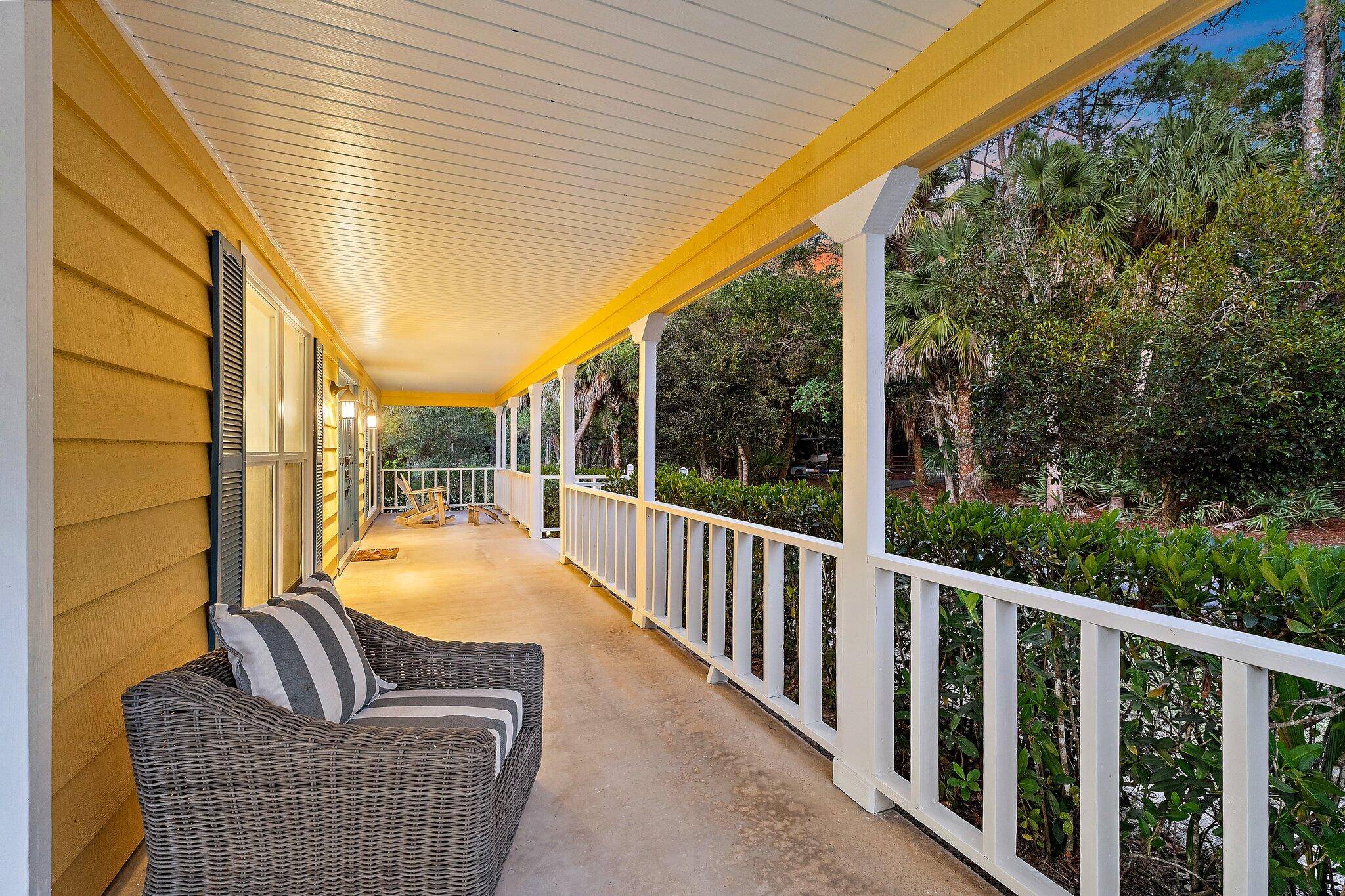17375 Thunder Road — covered front porch with white railings, columns and wicker seating