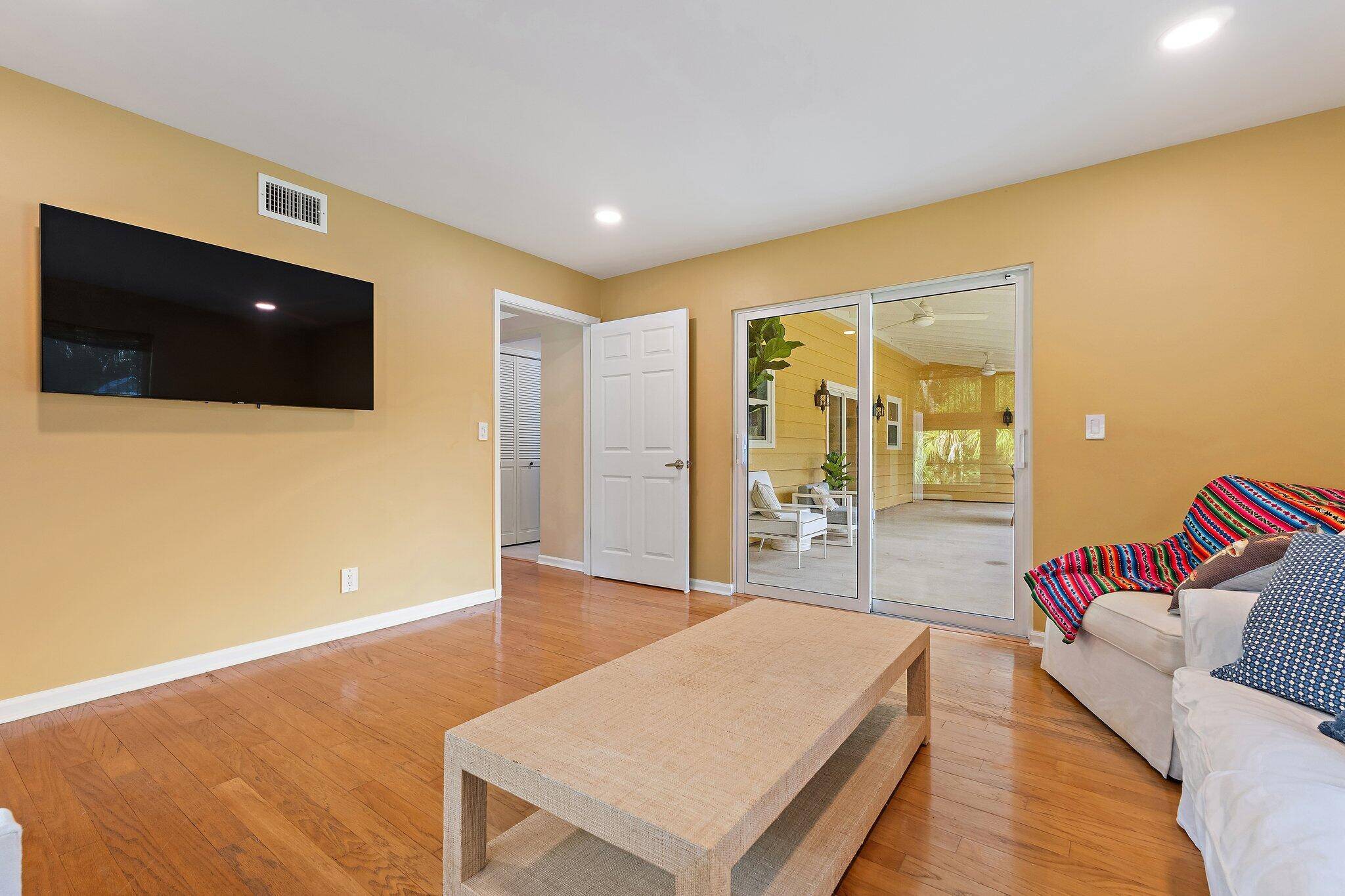 17375 Thunder Road — living room with hardwood floors and sliding glass doors to covered porch