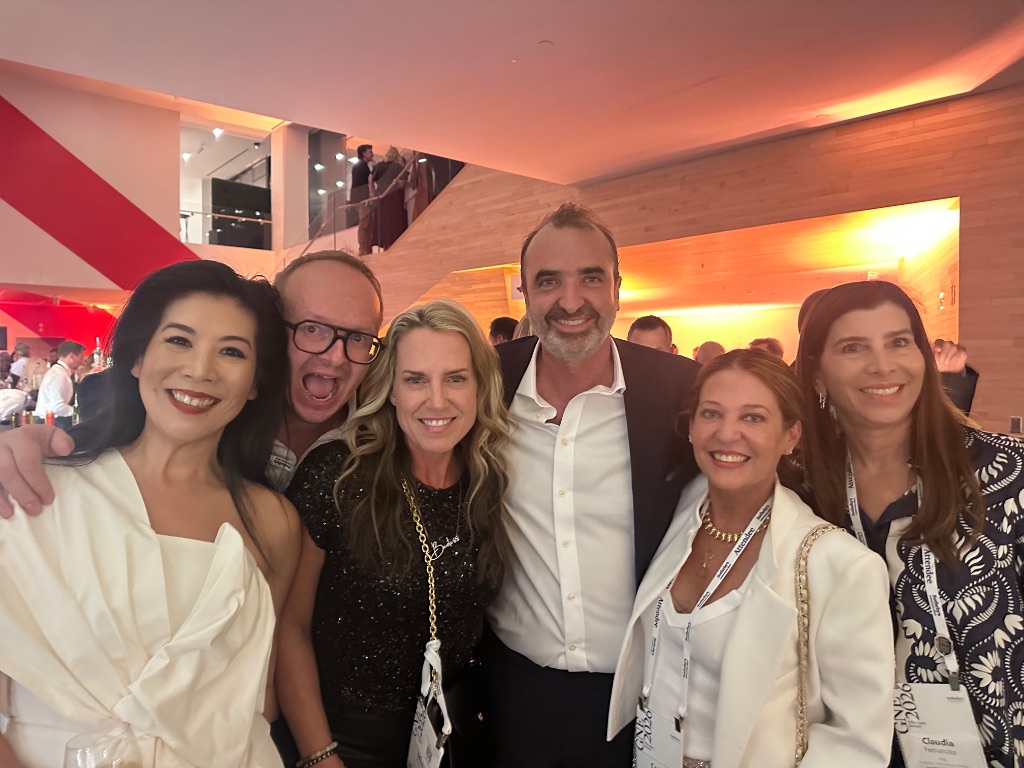 A joyful group of six Sotheby's International Realty professionals at an evening networking reception during the 2026 Global Networking Event in San Francisco